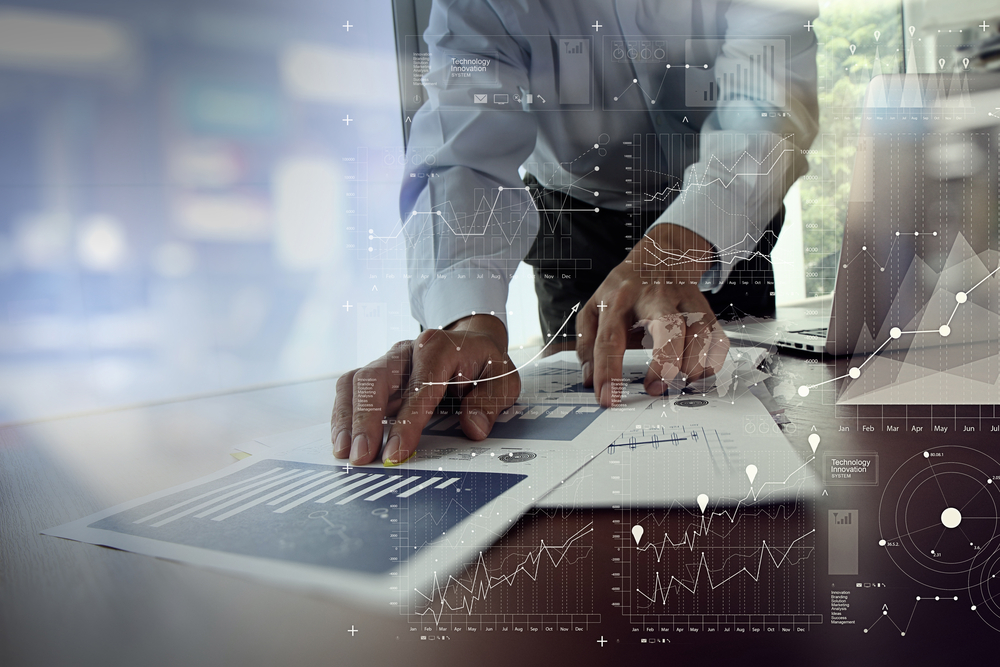 close up of businessman hand working on laptop computer with financial business graph information diagram on wooden desk as concept close up of businessman hand working on laptop computer with financial business graph information diagram on wooden desk as concept